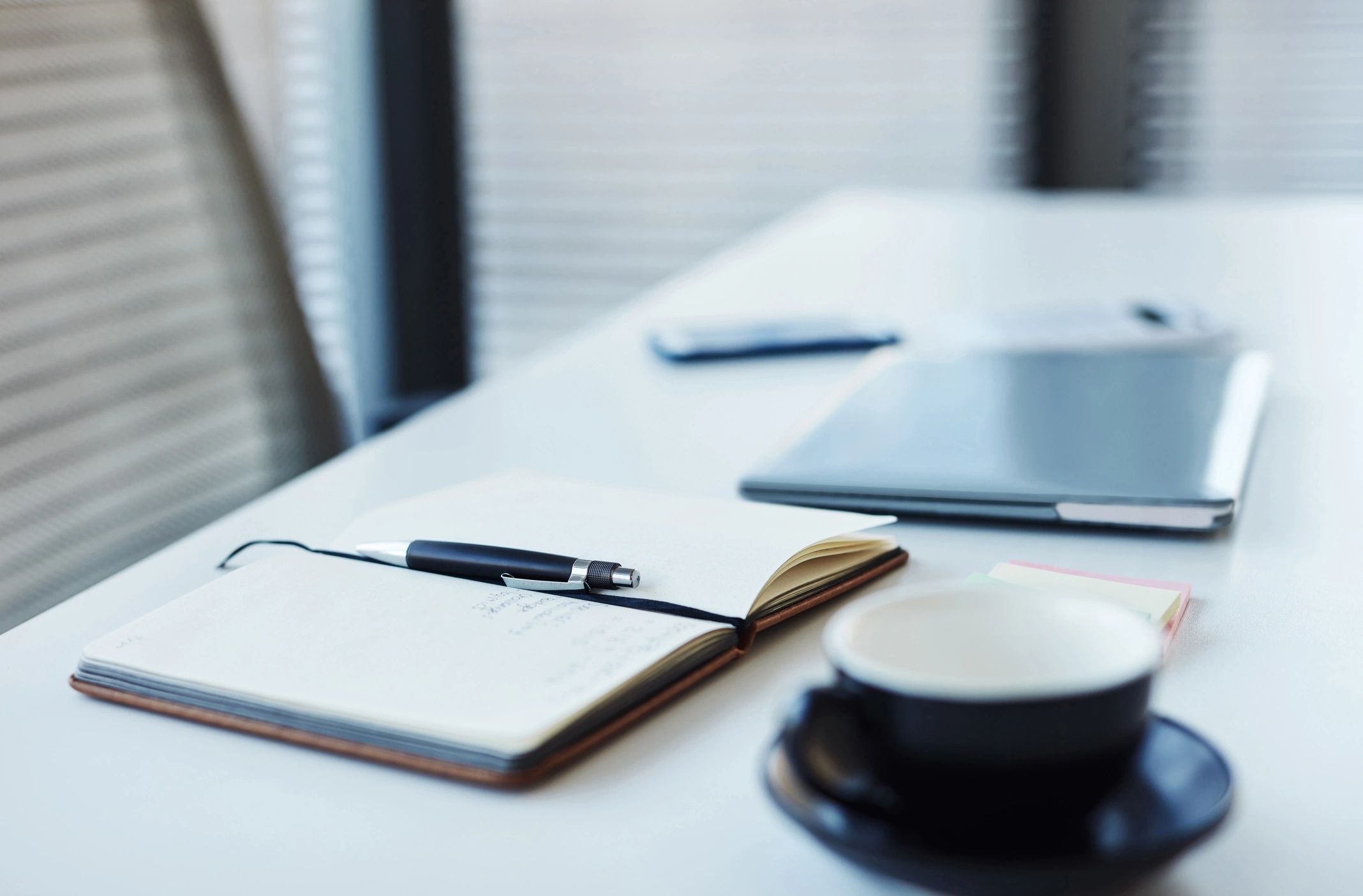 Notebook and laptop on a desk representing structured planning